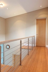 BAMBOO HANDRAIL ON STAINLESS STEEL UPRIGHTS. SPECIAL STAINLESS STEEL DETAIL IN THE HANDRAIL 